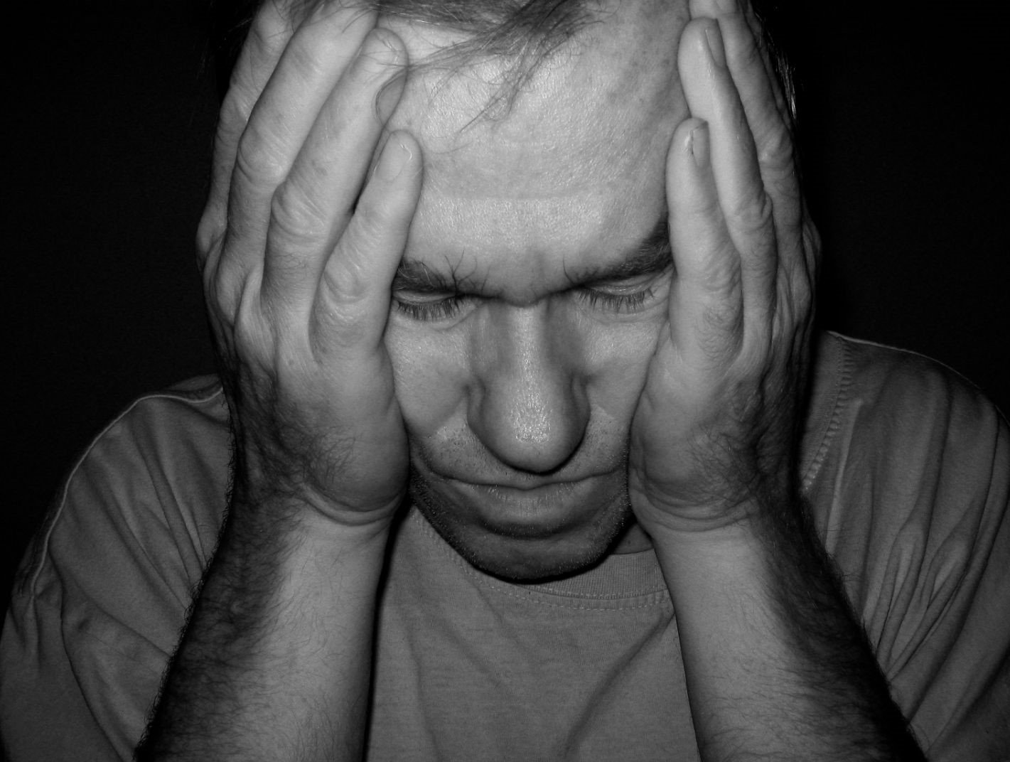 person holding their head in their hands