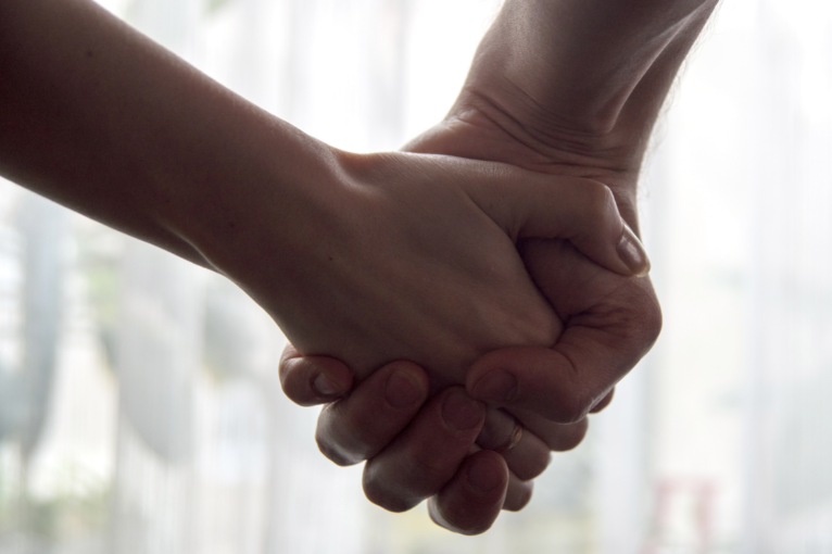 two hands clasped together