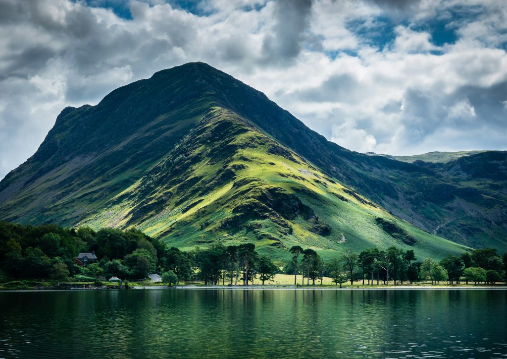 A photograph of a hill and lake in the Lake District
